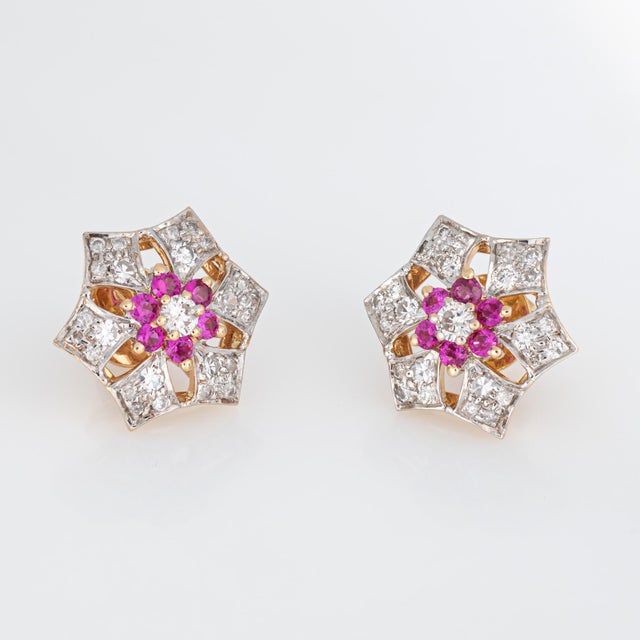 Stylish vintage ruby & diamond stud earrings crafted in 14k yellow gold (circa 1950s to 1960s). Diamonds total an...