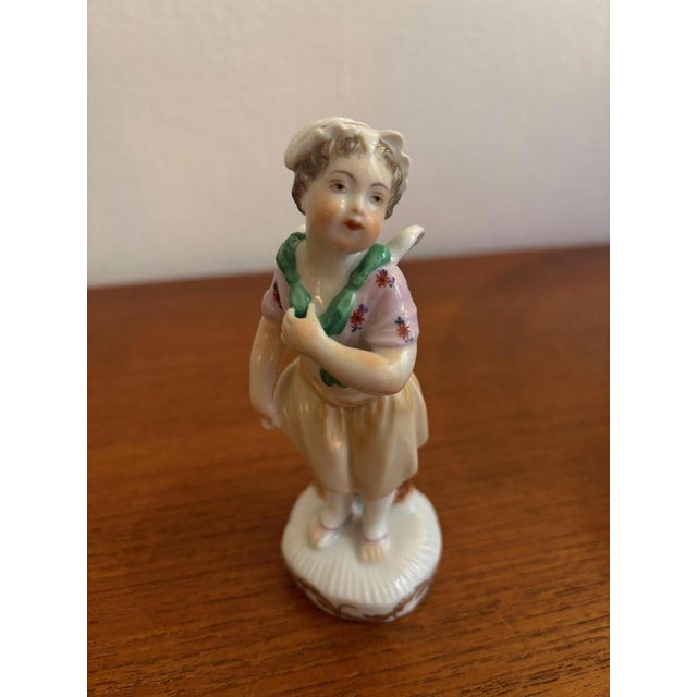 Female Cupid, Vienna Porcelain Manufactory Augarten Porcelain, polychrome decoration Underglaze blue mark Height: 11.5 cm,...