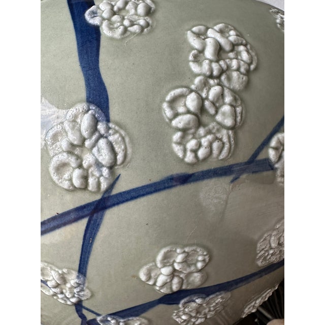 Large vintage celadon green ceramic ginger jar table lamp featuring an elegant Asian-inspired floral design. The rounded...