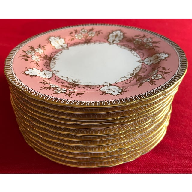 Set of 12 Aynsley pink and gold foliage bone china porcelain 8 3/8" plates. Nice shaped / scalloped rims with stylized oak...