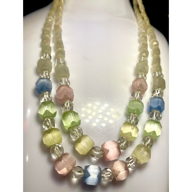 Art Deco Multi layer Pastel Colored Satin Glass Necklace With Ornate Sterling Silver Push Clasp Art. Item is 16” in length.