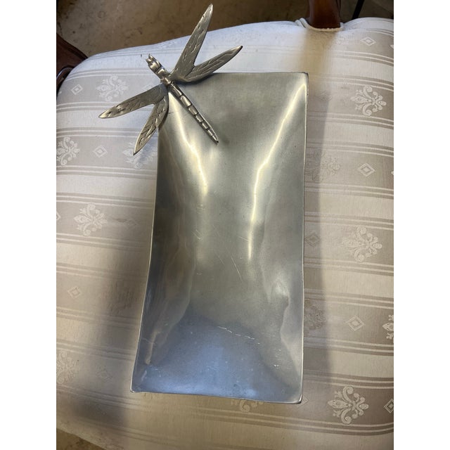 Vintage polished pewter serving dish features a distinct dragonfly accent created by Mexican artisans. Crafted from...