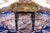 A lacquered tray table decorated with a hand-painted landscape featuring trees, birds, water and a distant tower, an...