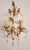 A stunning, hand-forged, handmade vintage wall sconce in a floral design, gilded in gold leaf with floral and leaf...