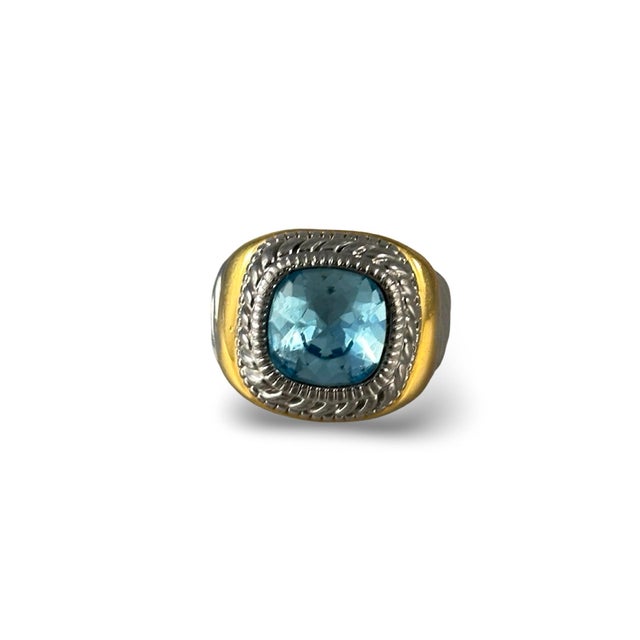 Gorgeous sterling silver and gold vermeil ring with faceted Blue Topaz gemstone. This is a new piece, never worn, in a...
