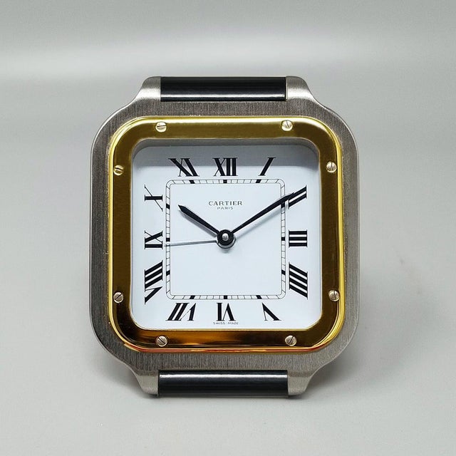 This stunning 1980s cartier santos pendulette alarm clock represents a sophisticated blend of functional design and...