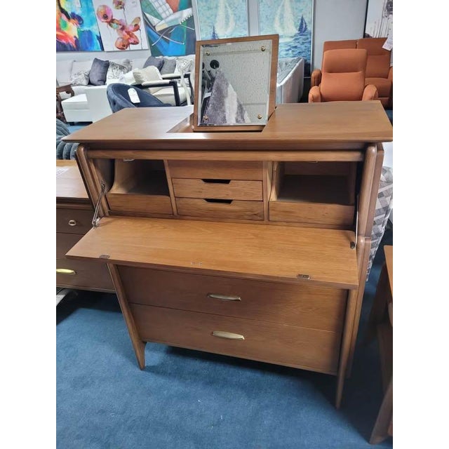 The Drexel Projection Dresser is a highly collectible piece of mid-century modern furniture designed by John Van Koert for...