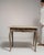 This 19th century Louis XV side table from France is finished in antique white, worked in oak. It is distinguished by its...