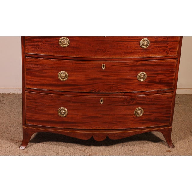Exquisite bombé mahogany commode from the Regency period, circa 1800. This commode is of exceptional quality, featuring...