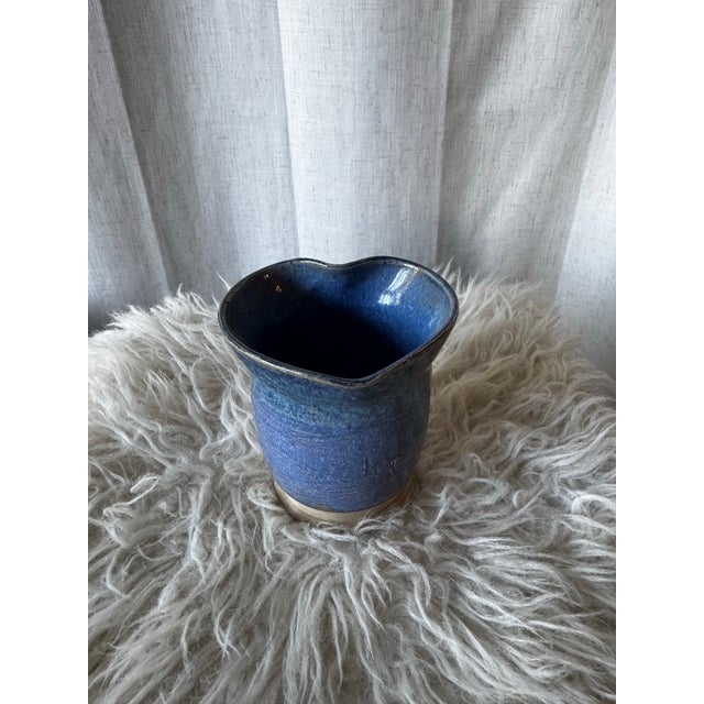 This vintage studio pottery vase features a deep blue, speckled glaze and a unique, hand-shaped heart form. Signed by the...