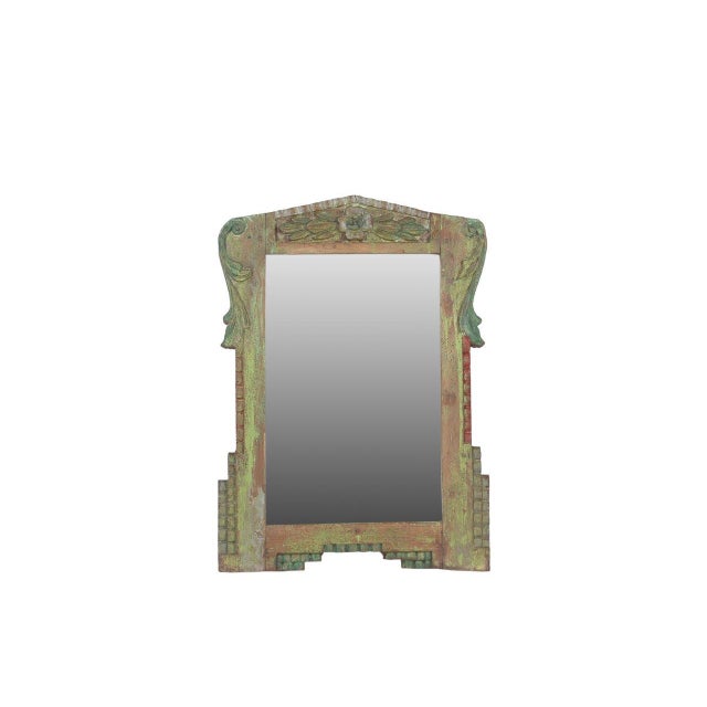 This Vintage Indian Painted Teakwood Mirror is a charming decorative accent crafted from solid teakwood and featuring...