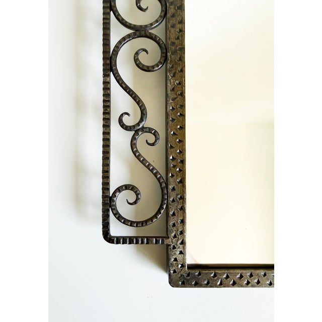 Vintage bronze framed wall mirror, hand-forged, dated 1935 on the back panel. The frame has a modernist sensibility, with...
