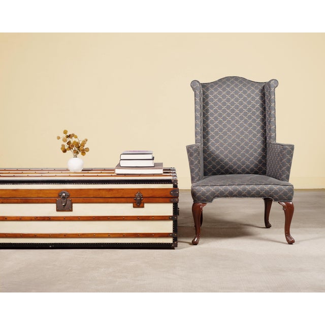 A handsome bespoke mid-century wingback chair crafted in the English Georgian taste. The chair features a hump shaped...