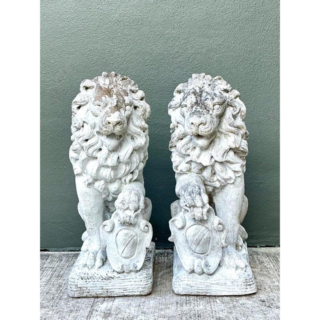 This commanding pair of vintage Italian cast cement lion statues depicts two heraldic guardian lions seated upright, each...