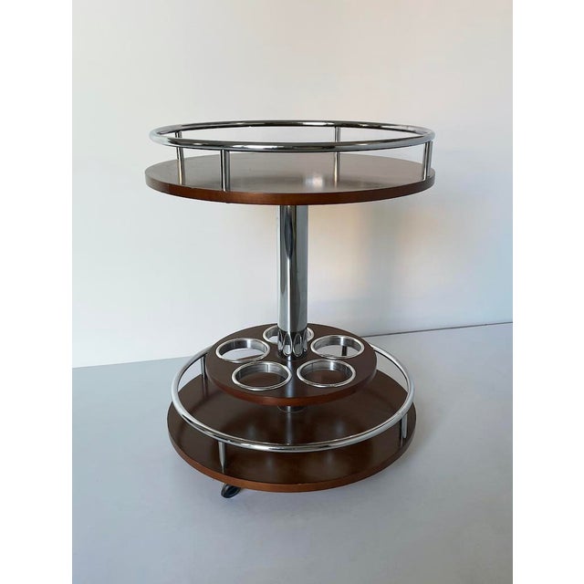 Unique vintage 1970s bar cart, made entirely of mahogany and tubular steel, with four wheels at the base for easy...