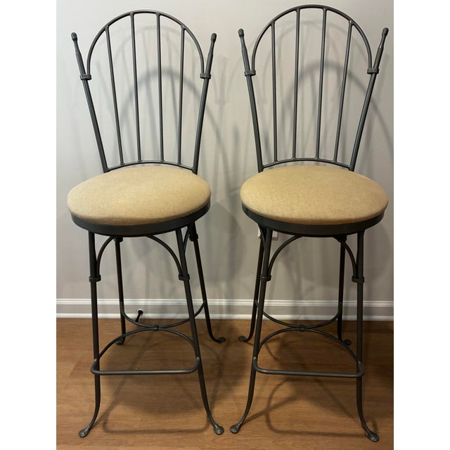 A pair of Handmade Bar Stools by Charleston Forge, known for their commitment to American Craftsmanship blending strength...