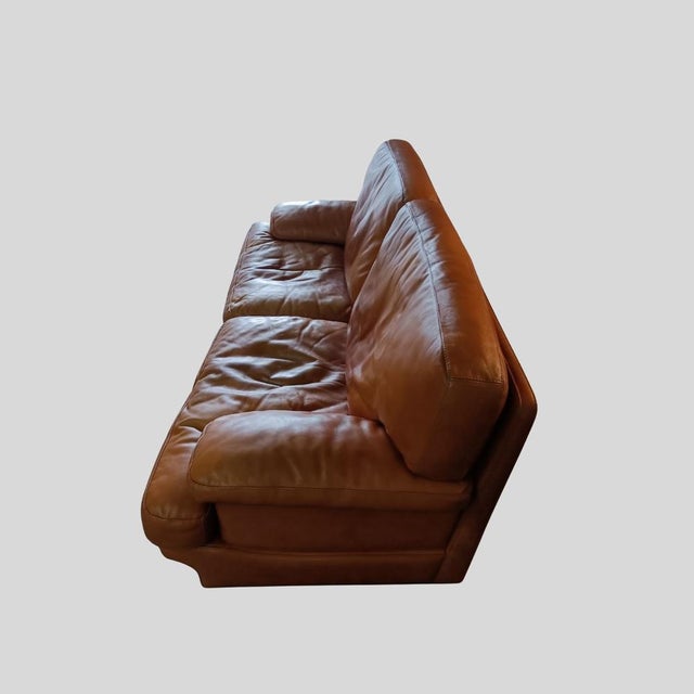 This vintage Italian leather sofa set, consisting of a spacious three-seater and a matching two-seater, dates from the...