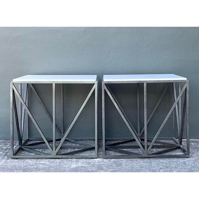 This pair of side tables is a sophisticated example of modern architectural design, blending sharp geometric lines with...