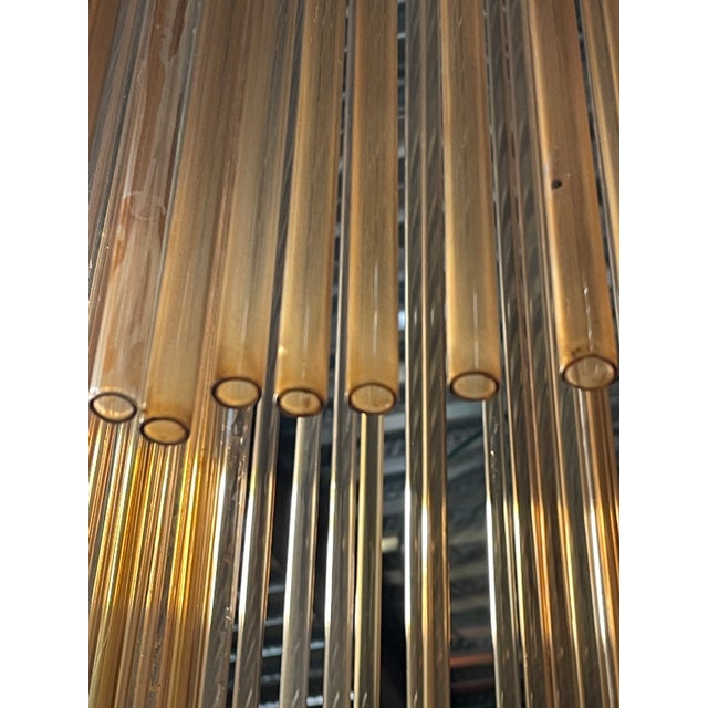 Pendant lamp from the late 1960s and early 1970s, composed of 76 tubular pink glass rods attached to a square metal...