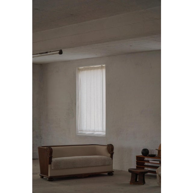 A beautiful and rare antique sofa from the mid-19th century in the decadent Empire style. The sofa features a gracefully...