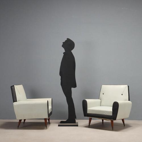 Pair of vintage armchairs with foam and spring padding, featuring the original period two-tone vinyl upholstery. This...