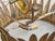 A Spanish midcentury gilt metal chandelier with dramatic leaf-form details and frosted glass diffuser. Crown-like in form,...