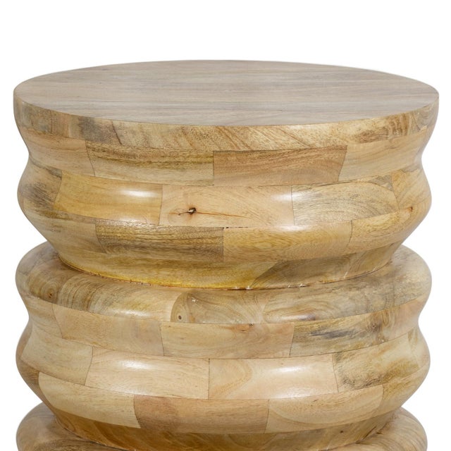 The Aria Wood Accent Table is a captivating natural beauty crafted from wood. Its ribbed, cylindrical shape is juxstaposed...