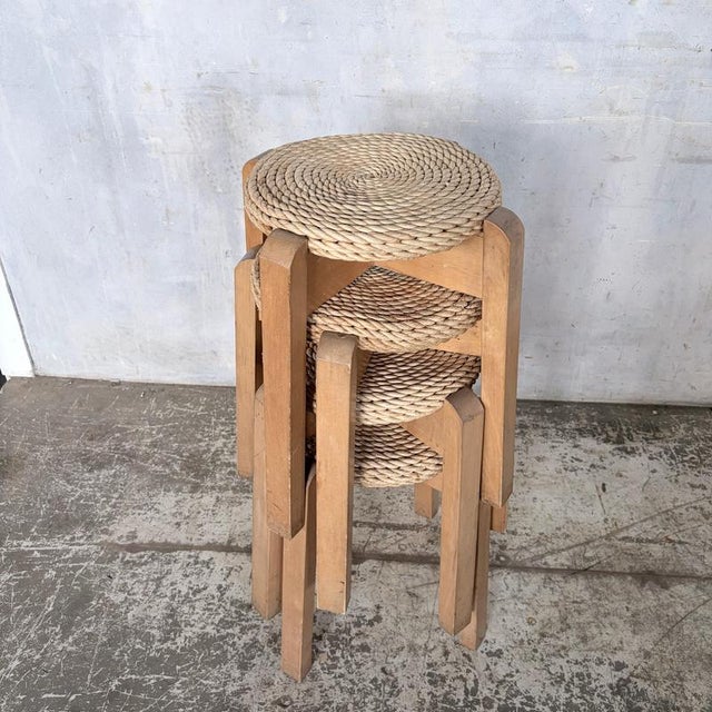 A charming set of four mid century stackable stools, crafted from solid beech with beautifully hand-woven natural rush...