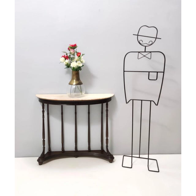 Made in Italy, 1960s. It features a turned beech frame with a demilune Portuguese pink marble top. This console might show...