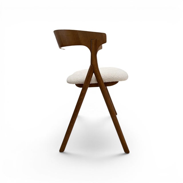 A stylish set of eight Italian dining chairs showcasing the clean lines and refined craftsmanship characteristic of mid-...