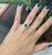 A vivid 1.6 ct Zambian emerald (8mm) set in solid 14K gold, accented with earth-mined diamonds for radiant contrast. Lush...