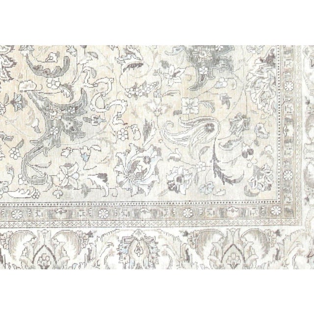 Expertly crafted in the traditional Tabriz style, this Semi Antique Persian Rug is a true work of art. Measuring 9'9" x...