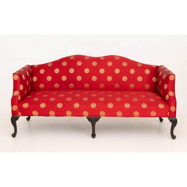 Queen Anne Style Camelback Sofa, with red and golden silk si bat pattern upholstery on six carved mahogany cabriole legs....