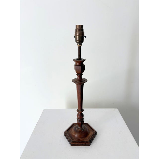 An early 20th century antique table lamp with a delicately turned wooden form. The decorative hexagonal base gives rise to...