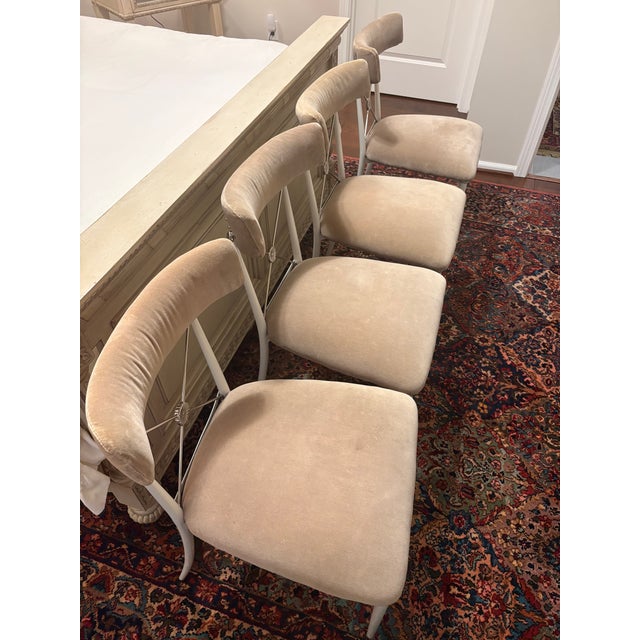 Beautiful set of four authentic Jonathan Adler Rider Dining Chairs in ivory velvet with white lacquered metal frames and...