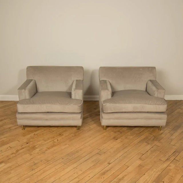 A pair of Mid-Century oversized Italian club chairs with bronze legs, C 1950. Newly upholstered.