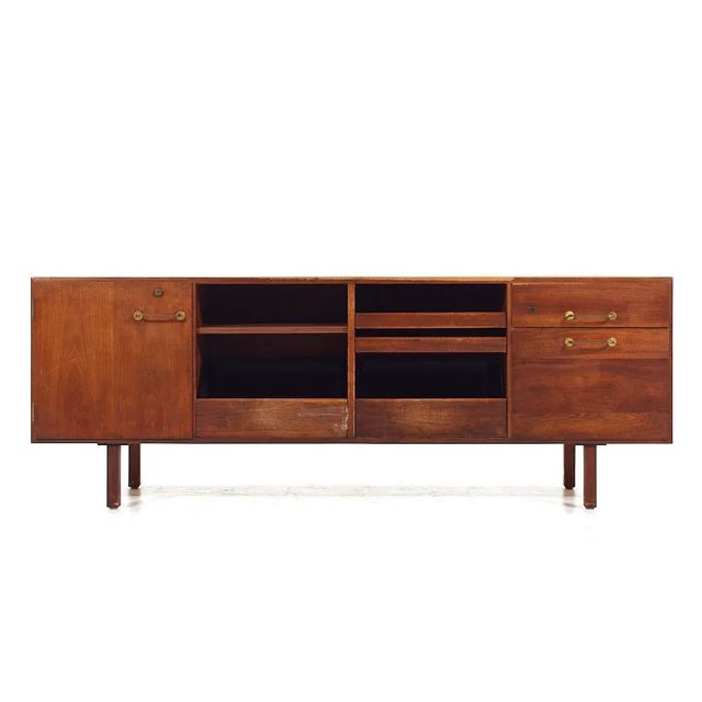 Jens Risom Mid Century Walnut and Brass Credenza This credenza measures: 72 wide x 20.25 deep x 26.25 inches high When you...