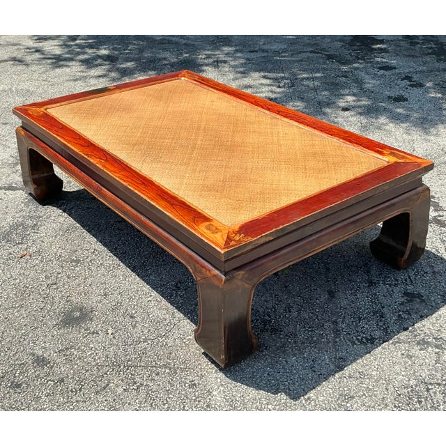 Infuse your space with the serene elegance of this Vintage Asian Elm and Seagrass Ming Coffee Table. Crafted from rich elm...