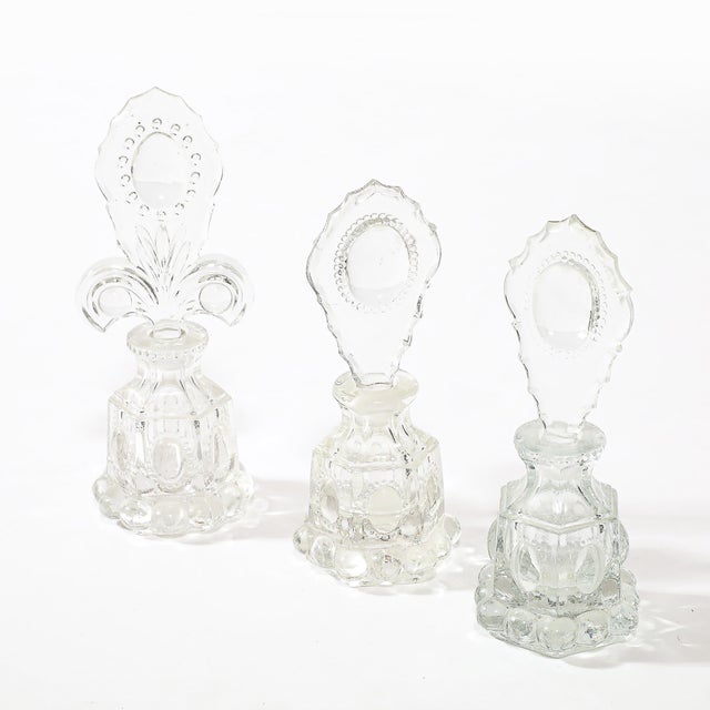 This stunning set of three Art Deco pressed glass perfume holders epitomizes the elegance and innovation of 1930s American...