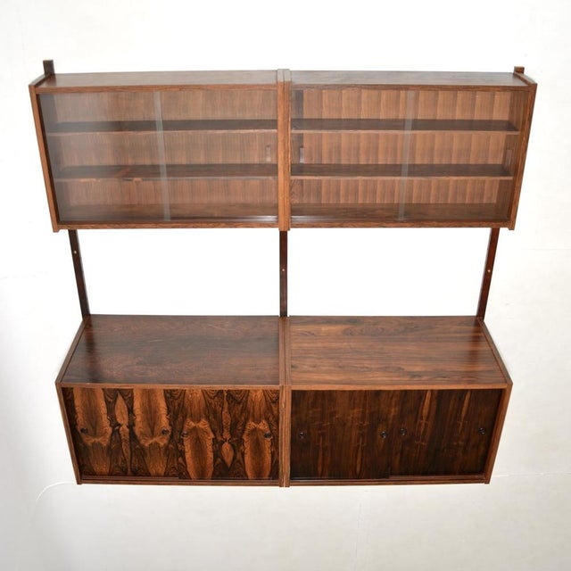 A stylish and versatile Danish vintage wall mounting cabinet by Preben Sorensen. Known as the PS system, this was made in...