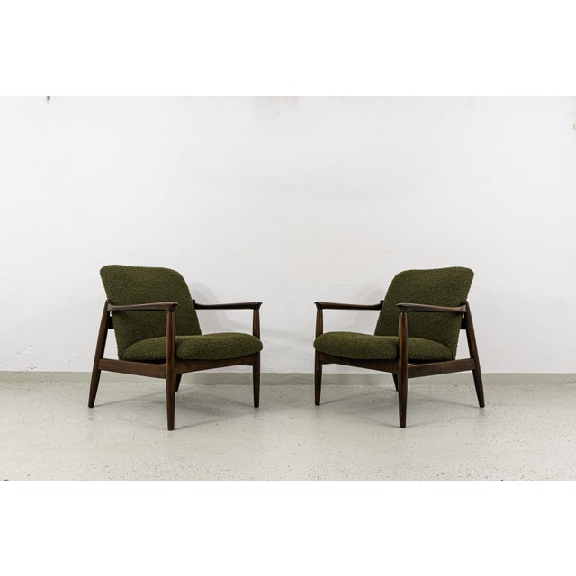 A pair of GFM-64 armchairs designed by Edmund Homa, produced by the Gościcińska Fabryka Mebli (GFM) in Poland during the...