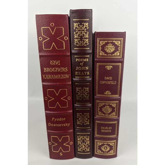A handsome collection of three vintage Easton Press leather-bound literary classics, presented in rich burgundy and red...