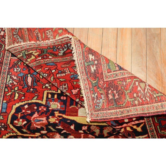 Super quality early 20th century Persian Sarouk Ferehan carpet. Deep red field and border with a navy blue medallion and...