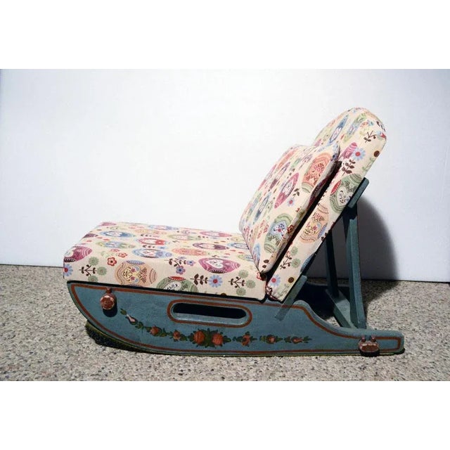 A set of two Tyrolean armchairs in solid wood with hand painted decorations. The base has a sled shape and the cushions...