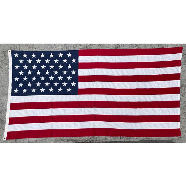 This is a 1970s Vintage 50-Star American Flag by Valley Forge Flag Co. The stars and stripes are machine-stitched and...
