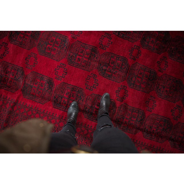 Triple column repeating Bokhara gul medallions atop a deeply saturated red ground. Colors and shades include: Cherry red,...