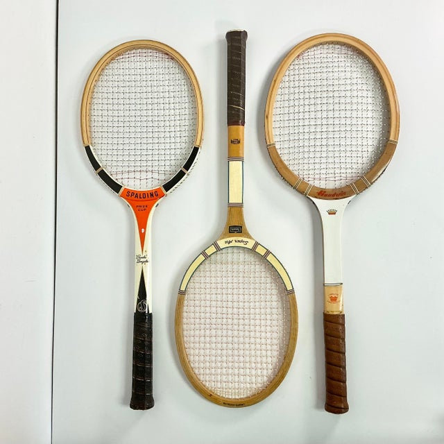 This is a set of Vintage Wood Tennis Rackets from the 1950-1970s. There is a red Spalding racket that is endorsed by...