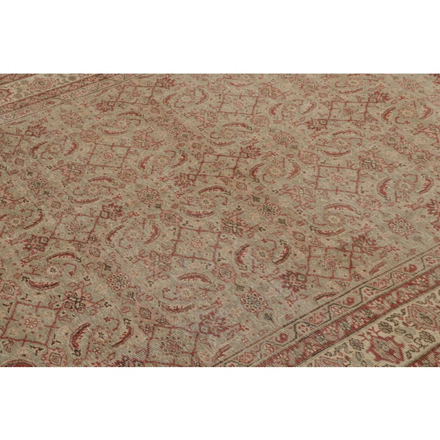 Hand-knotted in wool, this vintage 6x10 Turkish rug features a play of floral patterns in the field and border alike. On...