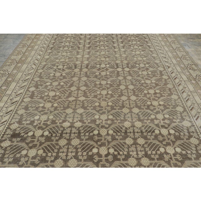 Hand-knotted in wool circa 1910-1919, this 9x17 antique East Turkestan Khotan runner is a regal addition to Rug & Kilim's...