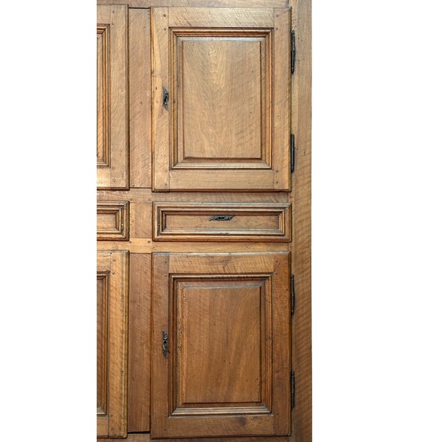 Impressive double-body sideboard in solid walnut, dating back to 1700, composed of four doors and two central drawers....